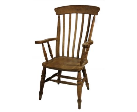 A stripped ash and elm grandfather chair, with comb top, lath back, scroll arms, shaped seat and ring turned forelegs joined 