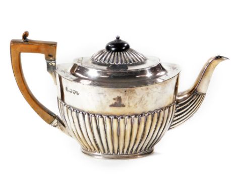 A Victorian silver teapot, of compressed oval form, part reeded with angular thumb mould handle, bearing Langham family crest