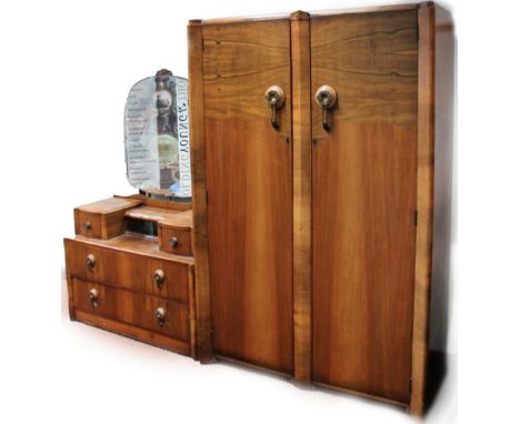 A 1930's walnut veneered bedroom pair, comprising of a double door wardrobe, 183cm x 121cm x 54cm, and a mirror back dressing