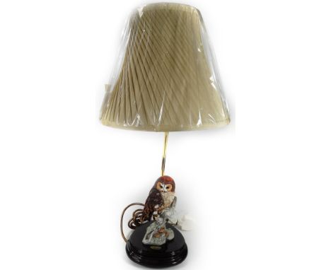 *An as new Florence lamp, with owl stem and material shade, 59cm H.