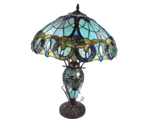 *An as new table lamp, with Tiffany style shade, set with a repeat floral pattern predominately in blue, orange and green, 66