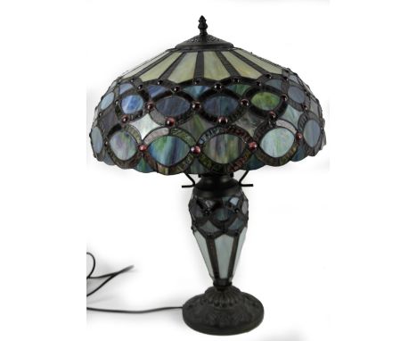*An as new table lamp, with Tiffany style shade, predominately in blue, red and green, 61cm H.