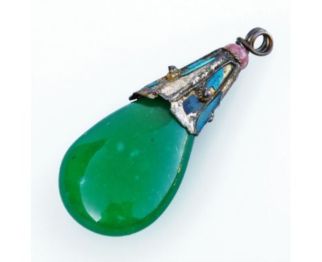 A Chinese green coloured glass stone pendant, the pendant head with blue enamel design, in single pink bead to top, on a jade