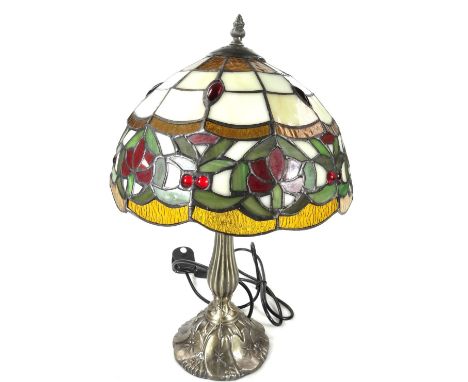 *An as new table lamp, with Tiffany style shade, with a repeat floral pattern predominately in cream, orange, red and green, 