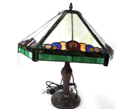 *An as new table lamp, with Tiffany style shade, decorated with flowers predominately in cream, red and blue, 53cm H.