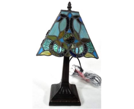 *An as new table lamp, with Tiffany style shade predominately blue, red and green, 40cm H.