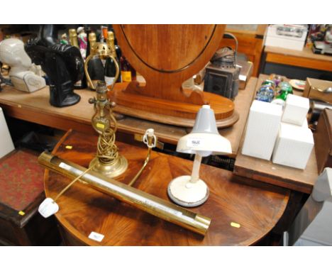 A brass gimballed lamp, a desk lamp and an overhead picture light