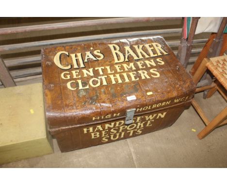 A painted and decorated metal storage trunk for "Chas Baker Gentleman's Clothiers"
