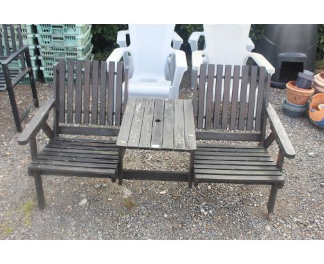 A two seater painted garden bench with fitted central table