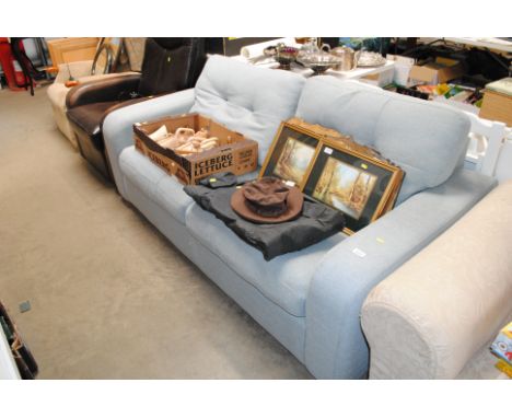 A blue two seater sofa