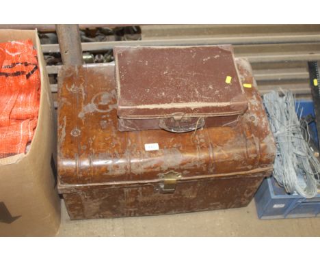 A metal dome topped trunk and a small briefcase