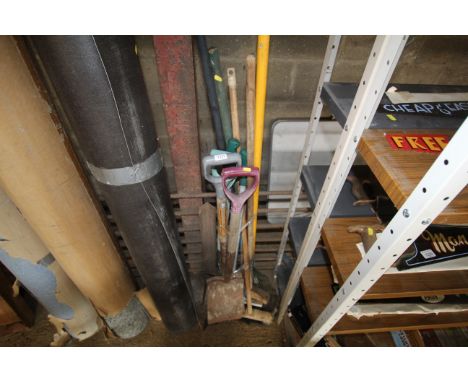 A quantity of long handled garden tools to include digging fork, brooms garden rake etc.
