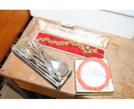 A silver preserve spoon, two silver cake forks, various plated items, a coral bangle and a costume necklace