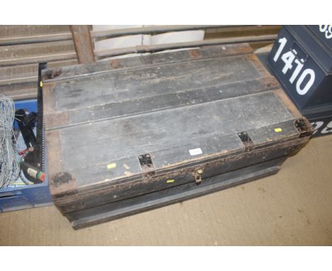 A wooden and metal bound storage trunk with metal liner 