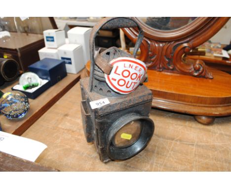 A vintage railway lamp and a LNER lookout enamel arm badge 