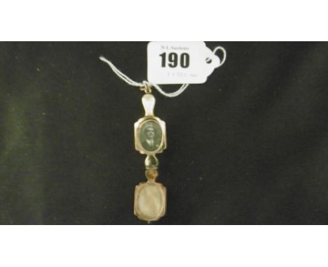 A YELLOW METAL AND ENAMEL LOCKET IN FORM OF A PAIR OF LORGNETTES, RINK MARKED 9CT