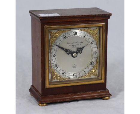 An Elliott mantel clock, the silvered dial with retailers mark for Garrard &amp; Co. chapter ring with Roman numerals denotin