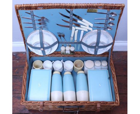 A large wicker picnic hamper by Sirram, the fitted interior containing assorted flatware, plates, cups and flasks etc. 
