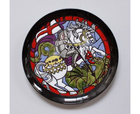 A Poole Pottery 'The Saint George Plate', depicting Saint George mounted on a horse slaying the dragon, designed by Tony Morr
