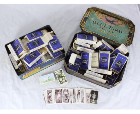 Two tins of assorted cigarette cards, predominantly arranged into sets and stored in Churchman's 'Tenner' packs, including Wi