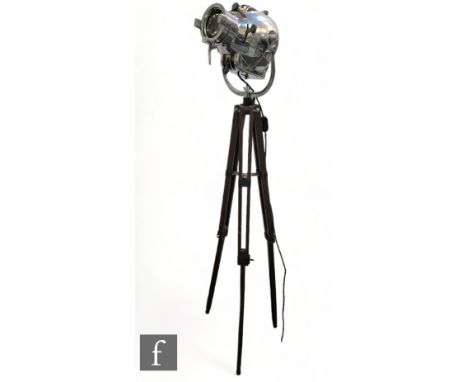 Strand Electric - A mid Century theatre spot light, the polished chrome on hinged frame, mounted on a later wooden tripod sta