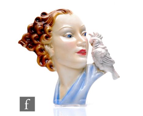 Goebel - An Art Deco face mask, pattern number 108, modelled as a young lady in half profile with a parakeet to her shoulder,