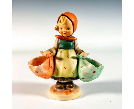 Hand painted porcelain in matte finish. Young girl holding a basket in each hand. Impressed M. I. Hummel to round base. Goebe