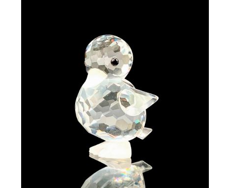 A clear crystal figure that depicts a small duckling that has black crystal for the eyes and frosted crystal for the bill and