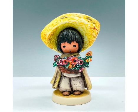 This Goebel by Ted DeGrazia porcelain figurine depicting a boy with colorful flowers is from The Wistful Children of De Grazi