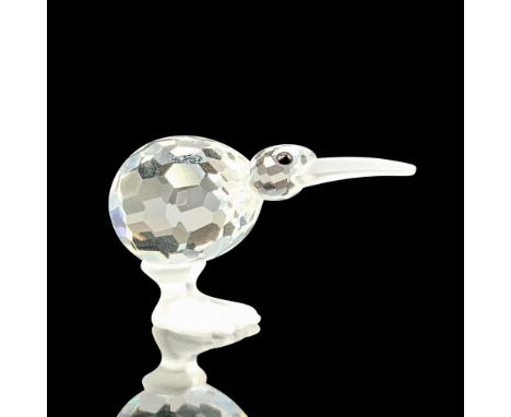 A clear crystal figure of a kiwi standing up facing straightforward with black crystal for the eyes and frosted crystal for t