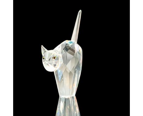 A clear crystal figure of a cat in a scared position with its back and tail raised that has melon-colored eyes. Swarovski bac