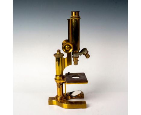 A monocular style antique microscope with a double nosepiece and mirror light source. Separate coarse and fine adjustment foc