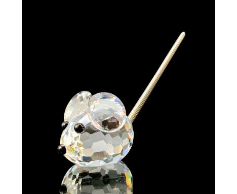 A clear crystal figure of a tiny round mouse with black crystal used for the eyes and nose with a metal coil tail. Swarovski 