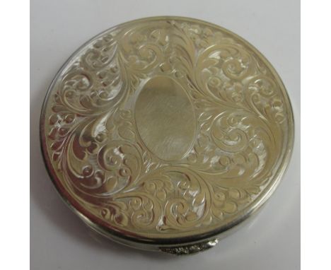 A HM silver compact by Mappin & Webb with engraved floral design