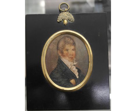 A portrait miniature of a gentleman in blue jacket and white cravat