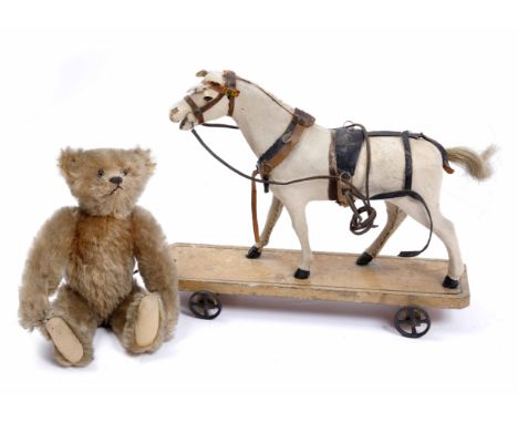 AN EARLY STEIFF PLUSH TEDDY BEAR 23cm high together with an antique pull along horse toy (2)