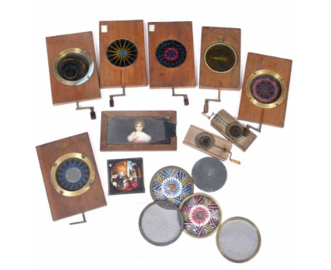 A GROUP OF 19TH CENTURY AUTOMATON MAGIC LANTERN SLIDES many with kaleidoscope type decoration together with various parts 