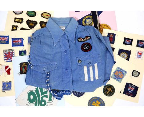 A 1950'S GIRL GUIDES BLOUSE with badges