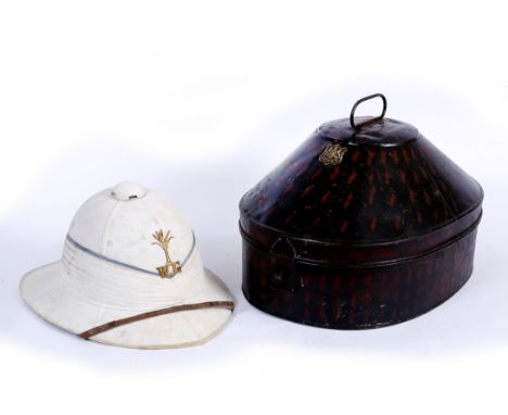A LATE 19TH / EARLY 20TH CENTURY WELSH PITH GUARDSMAN'S HELMET and original tin, makers label to the tin and the interior of 