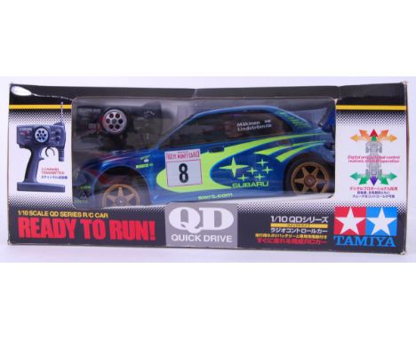 TAMIYA: A Tamiya ' Quick Drive ' 1:10 scale Subaru Impreza WRC. Within the original box. Appears to be unused, complete with 