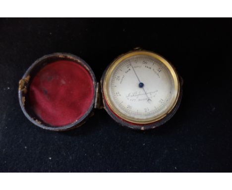 A 19TH CENTURY BRASS CASED POCKET BAROMETER, the silvered face engraved, 'Klaftenbeger Regent Street' with an outer leather c