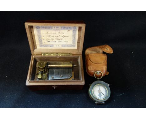 A POCKET COMPASS with leather outer case and a small Swiss music box (2)