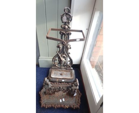 A VICTORIAN GOTHIC STYLE CAST IRON BOOT SCRAPER and a Victorian cast iron stick stand