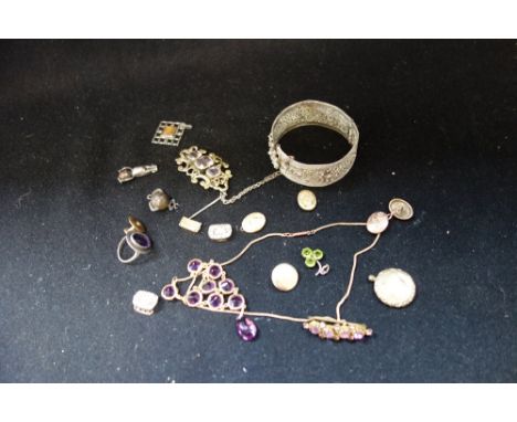 A COLLECTION OF COSTUME JEWELLERY, including a unmarked white metal bangle, decorated with floral filigree work.