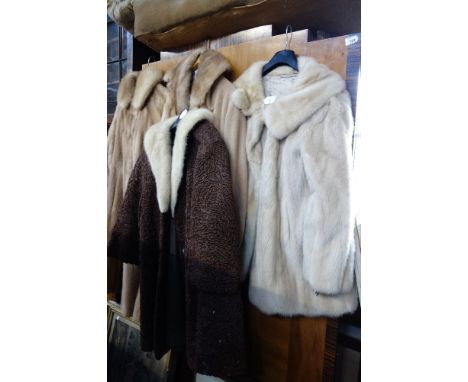 FOUR FUR COATS, including a brown Astracan coat