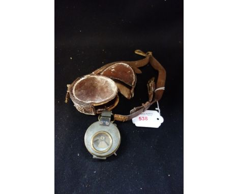 A WORLD WAR I BRASS CASED COMPASS, with outer leather case with Sam brown clip