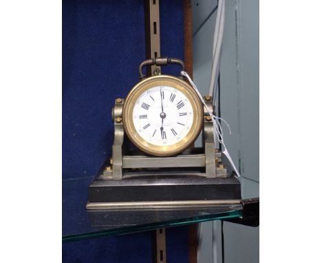 A VICTORIAN CLOCK in the form of a 'spot light' the face marked, 'H.M. Emanuel &amp; Sons Portsea' on a polished slate base