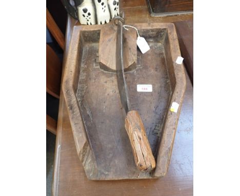 A BEECH AND IRON MOUNTED CHOPPING BOARD, first half 19th century, of canted rectangular form, the blade held with a hook term