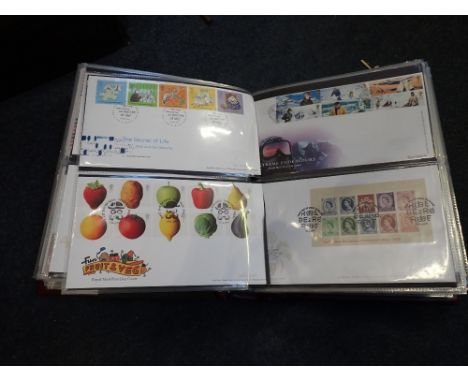 AN ALBUM CONTAINING FIRST DAY COVERS and similar