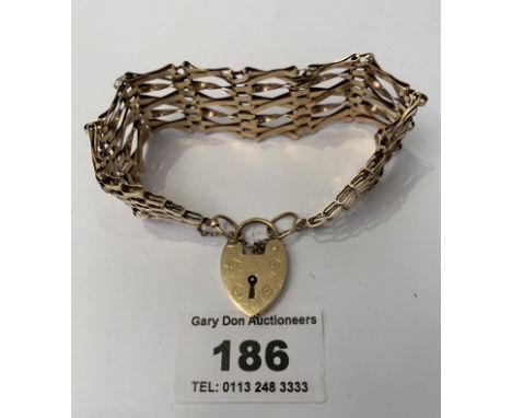 9k gold eight bar cross over link gate bracelet with safety chain and heart lock, w: 18.28 grams, length 7”
